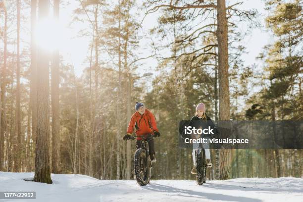 Father And Daughter Fatbiking In Nature Stock Photo - Download Image Now - Winter Sport, Cycling, Winter