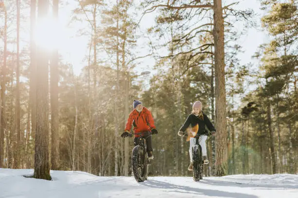 Photo of Father and daughter fatbiking in nature