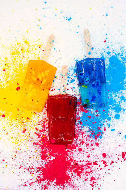istock Colored popsicles against multicolores explosion paint. Various bright ice cream. Summer concept. 1377434036