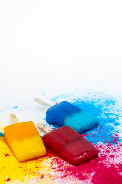 istock Colored popsicles against multicolores explosion paint. Various bright ice cream. Summer concept. 1377434051