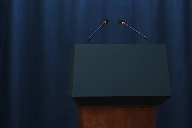An empty stage with a pedestal for a speaker An empty stage with a pedestal for a speaker presidential election stock pictures, royalty-free photos & images