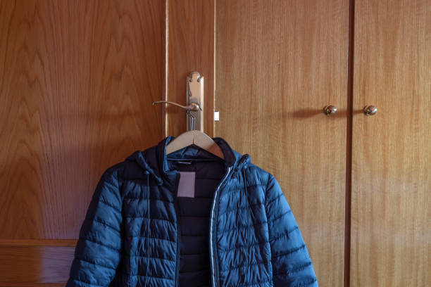 Madrid, Spain. January 22 2022. Winter coat hanging on doorknob lit by natural morning light