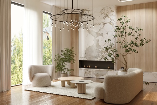 Elegant chandelier over coffee tables amidst furniture by fireplace in living room at contemporary apartment