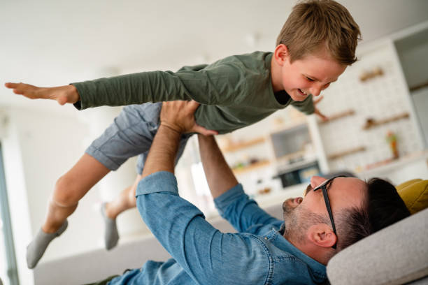 istock Joyful father and son having fun, spending tim at home together. Single dad concept 1377459682