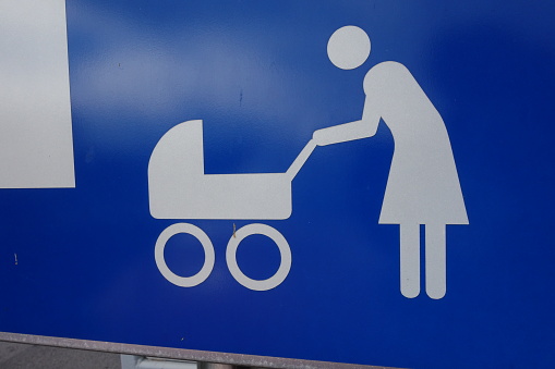 a mother with her child and baby stroller, maternity leave