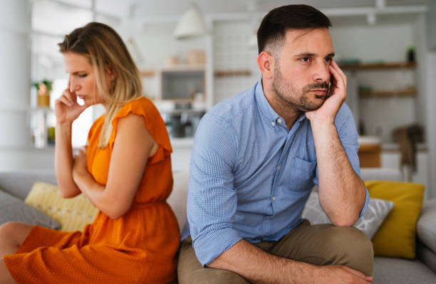 istock Sad pensive couple thinking of relationships problems sitting on sofa, conflicts in marriage. 1377461354