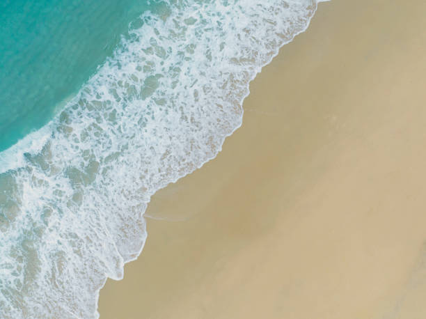 istock Top view Soft Wave Of Blue Ocean On Sandy Beach. Background-Summer concept 1377465077