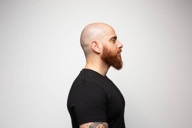 Close up profile of handsome young man Close up profile of handsome young man bald guys with beards stock pictures, royalty-free photos & images