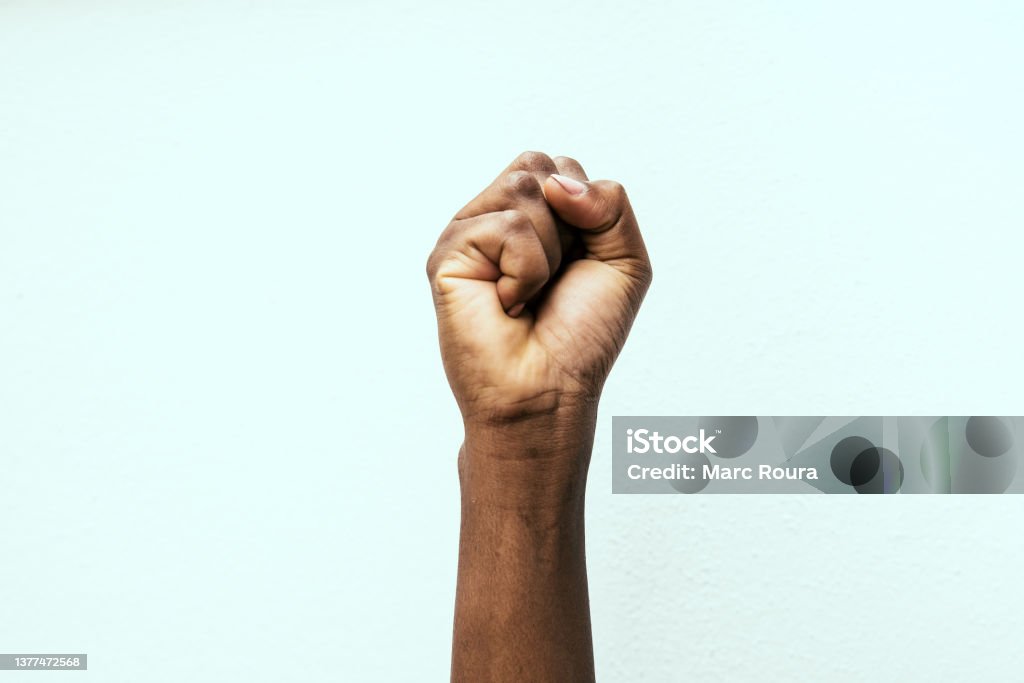 black fist black fist in the air as a sign of power Fist Stock Photo