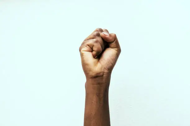black fist in the air as a sign of power