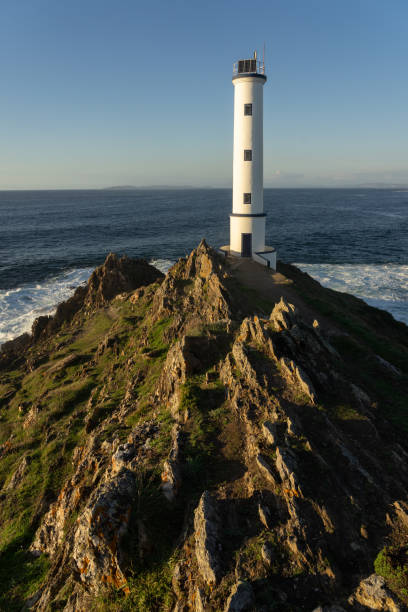 istock Cabo (cape) Home lighthouse on the cliffs at sunset in Rias Baixas zone in Galicia coast. 1377477416