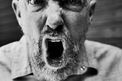Black and white close up of mans face with expressions