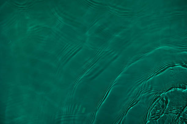istock transparent dark green colored clear calm water surface texture 1377519734
