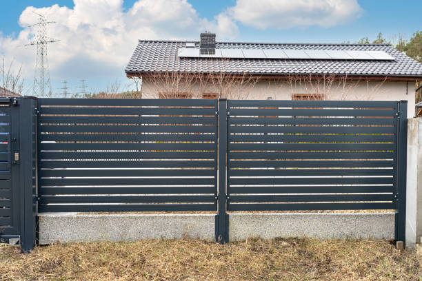 istock Modern anthracite panel fencing, visible spans and a fence foundation connector, view from the garden. 1377536588