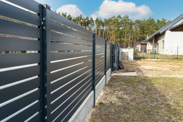 istock Modern anthracite panel fencing, visible spans and a fence foundation connector, view from the garden. 1377537675