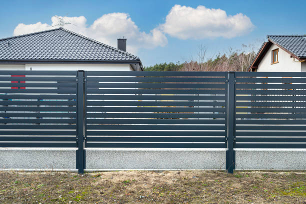 istock Modern anthracite panel fencing, visible spans and a fence foundation connector, view from the garden. 1377537679