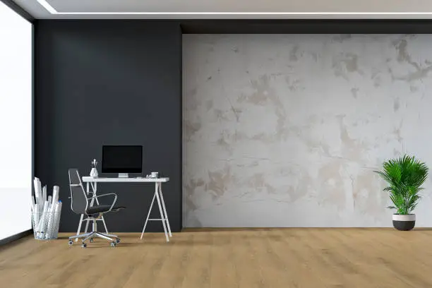 Home office -workdesk with computer, equipment, potted plant (howea forsteriana) and decoration on hardwood floor in front of empty partly anthracite, partly white ruined plaster wall with copy space. 3D rendered image.