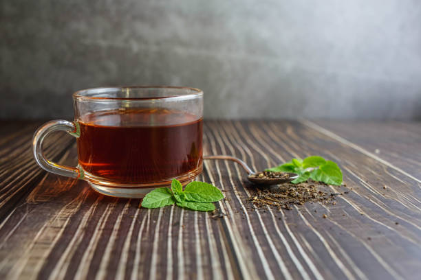 istock tea in glass cup on wooden background 1377596878