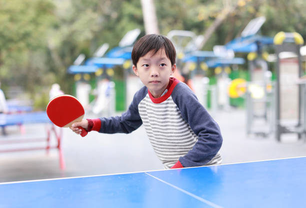 Ping pong ball and rackets on yellow background