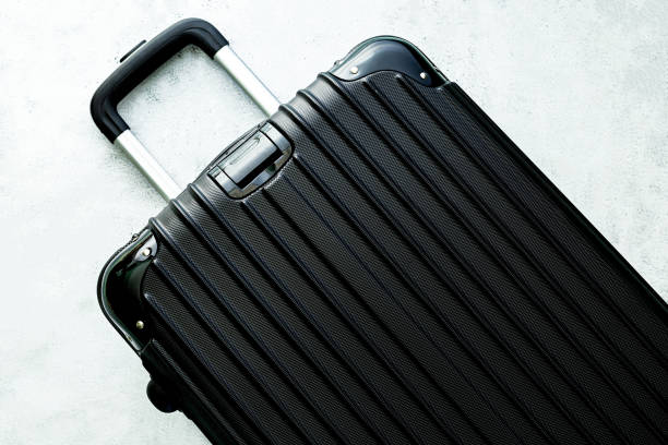 istock Luggage,black suitcase set on a white background top view image flat laying element Minimal travel concept. black and dark classic luggage prototype both small and large luggage accessory set travel concept 1377618782