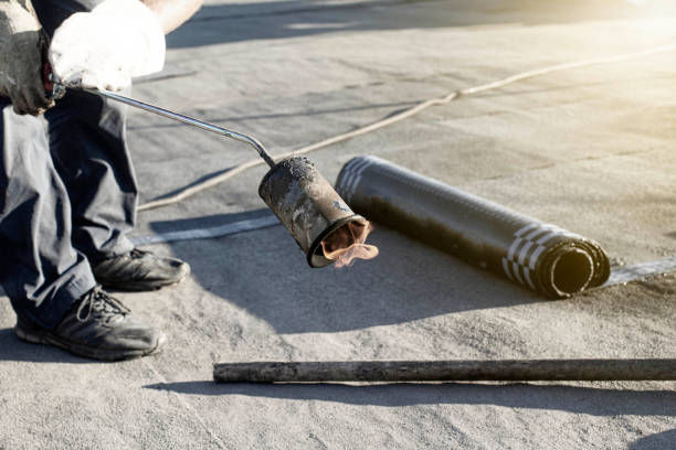 istock spring repair of a soft roof with rolled materials using a gas burner, the front and background are blurred with a bokeh effect 1377629079