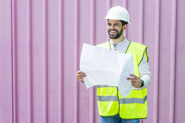 istock Portrait of a young civil engineer holding planning documents or technical drawing 1377634796
