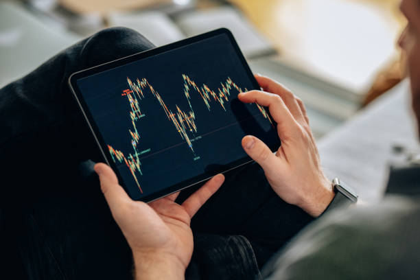 istock Trading At Home: Unrecognizable Man Holding a Tablet and Touching the Screen (Copy Space) 1377636694