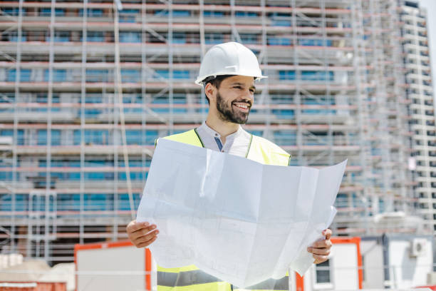 istock Portrait of a young civil engineer holding technical drawing 1377638945