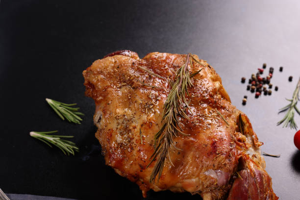 Roast Leg of Lamb with vegetables herbs and spices. High resolution image 45Mp taken with Canon EOS R5 and associate lens