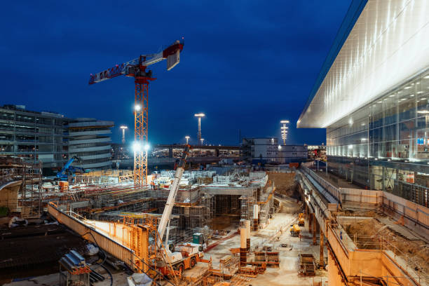 Construction site with crane - public works with illuminated site during the night stock photo