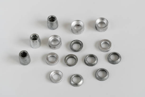 Isolated photo of worn, vintage and rusty metal and copper cloth buttons, hooks and decorative elements on white background.