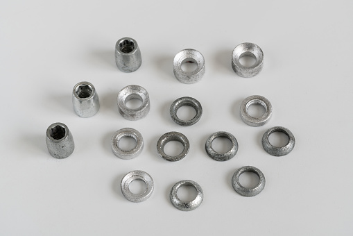 Closeup of nuts and washers on white background. connection material.