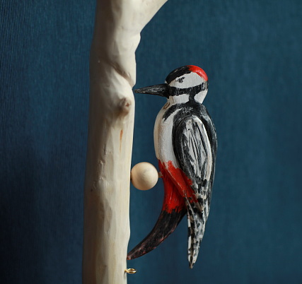 bird red-headed woodpecker wooden toy close-up