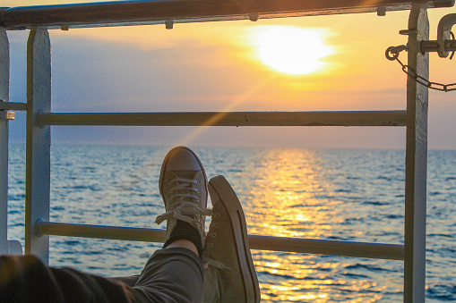 Feet on the railing of a cruise ship, somewhere in the Baltic Sea
