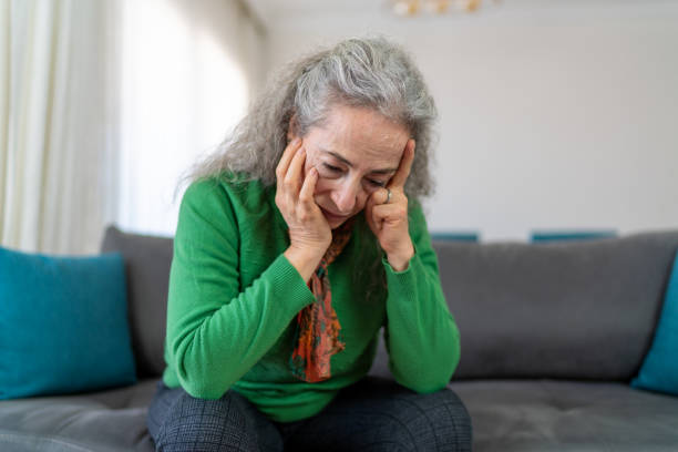 istock Senior Woman Sitting On Sofa At Home Suffering From Depression 1377716326