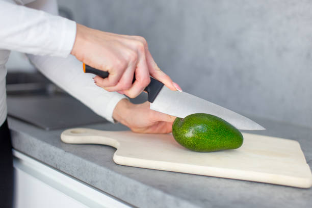 istock Woman hands preparing avocado closeup 1377727888