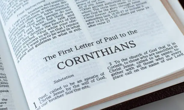Corinthians open Holy Bible Book close-up. New Testament Scripture. Studying the Word of God Jesus Christ. Christian biblical concept of faith and trust.