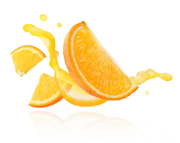istock Orange slices floating over juice splashing wave isolated on white background. 1377732836