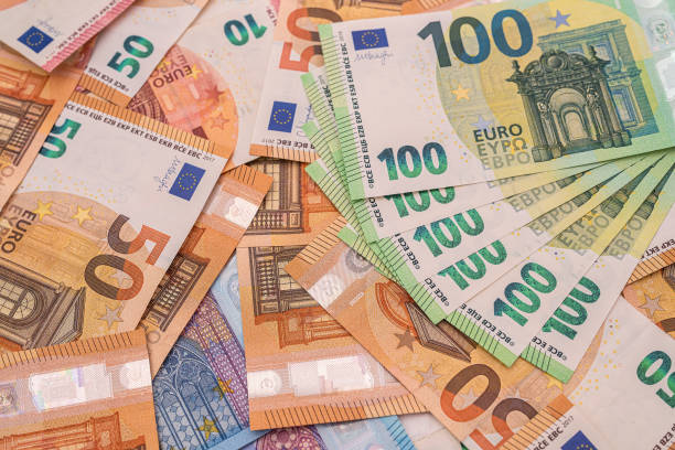 istock beautiful new clean multicolored euro banknotes scattered on the surface 1377736677