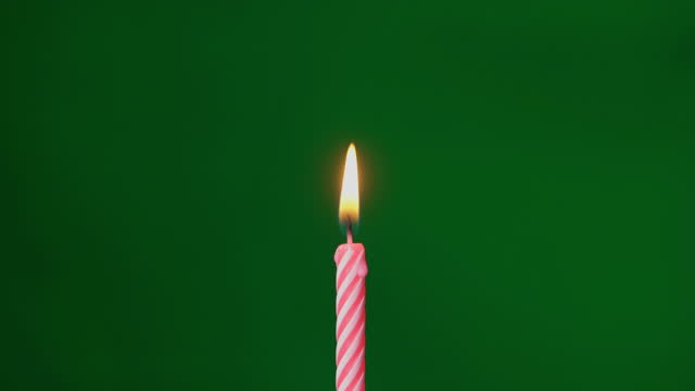 Red birthday celebration candle fire flame. Holiday party. Chroma key background