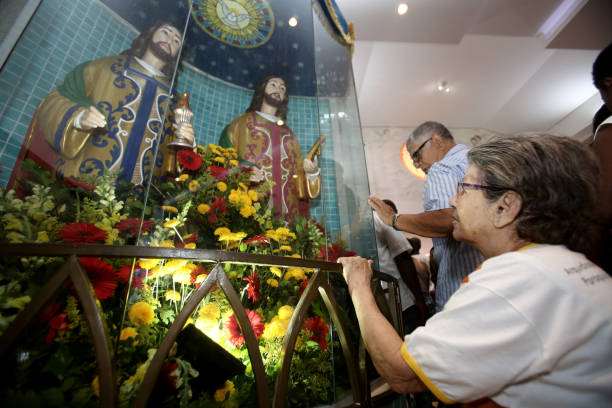 Mass in honor of Saint Cosimo and Saint Damiao salvador, bahia, brazil - september 27, 2017: Devotees of saints Sao Cosme and Sao Damiao attend mass in praise of the twin saints in Liberdade neighborhood in Salvador. Cosimo stock pictures, royalty-free photos & images