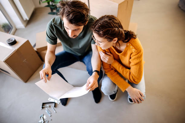 istock Happy couple analyzing plans at their renovating apartment 1377769123