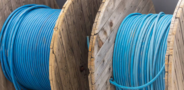 istock New blue power cable is wound on wooden coil. Background 1377810110