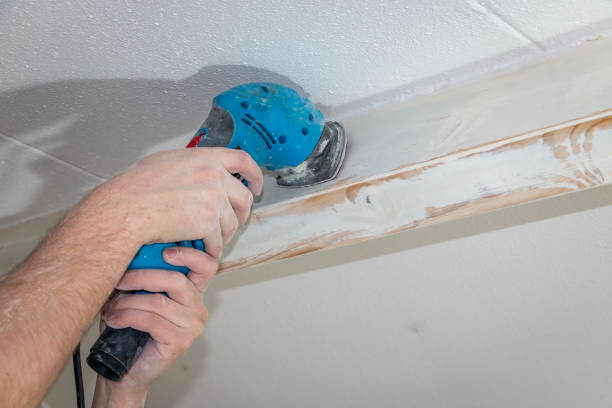 istock Sand the wooden ceiling beams with a sander and then paint them 1377818287