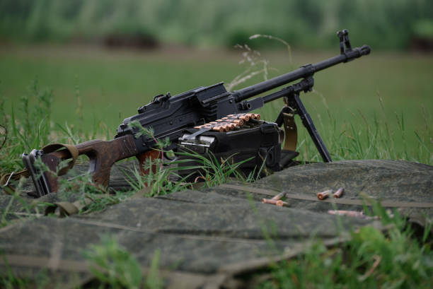 istock Kalashnikov assault rifles with ammunition on nature background 1377851286