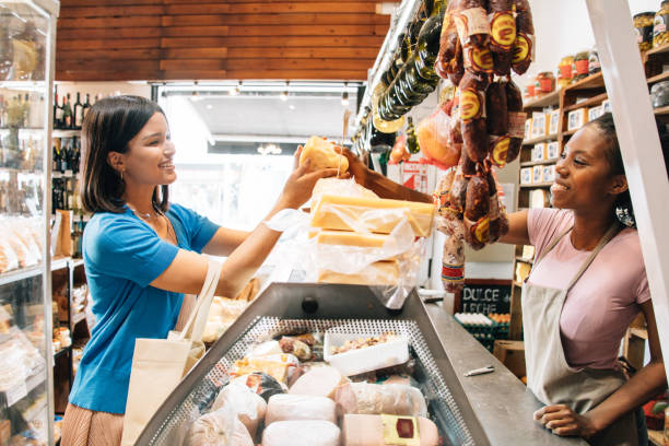 grocery store owner serving customer orders - cheese counter supermarket bildbanksfoton och bilder