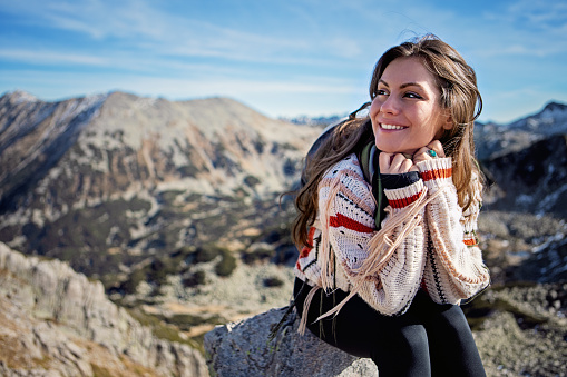 Hiker woman is enjoying view in a mountain
