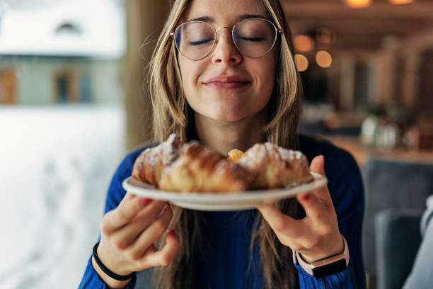 Teenage girl having breakfast Teenage girl having breakfast in restaurant. She is smelling fresh, warm croissants.
Canon R5 mouth full stock pictures, royalty-free photos & images