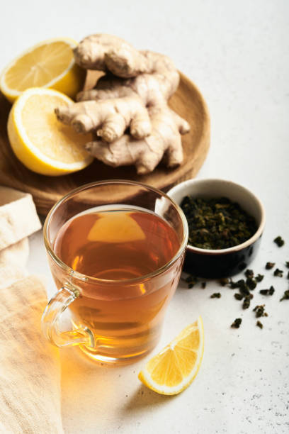 istock Ginger tea. Cup of ginger tea with lemon, honey and mint on grey background. Concept alternative medicine, natural homemade remedy for cold and flu. Top view. Free space for your text. 1377932669