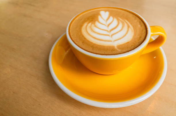 istock Yellow cup of cappuccino coffee with latte art 1377932691